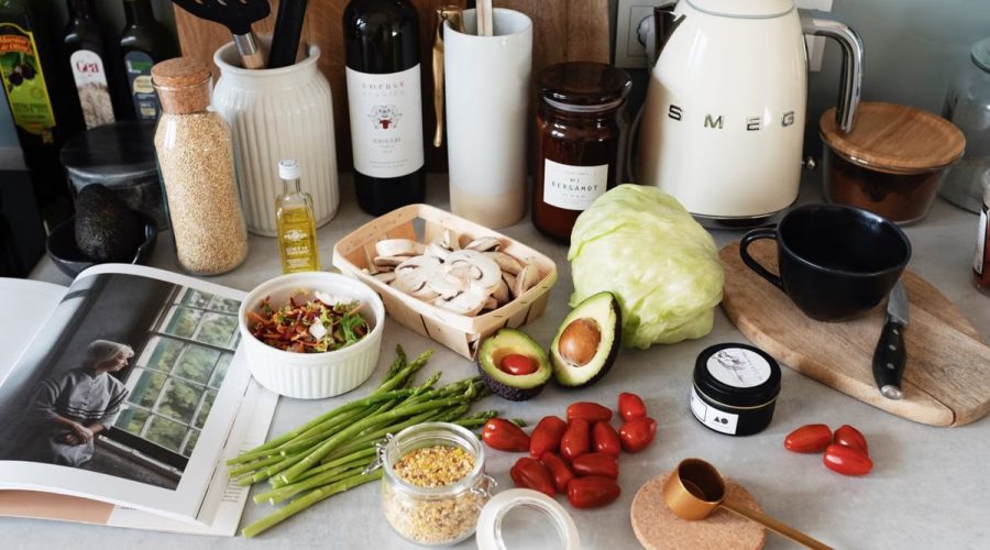 A variety of fresh ingredients and kitchen tools for preparing a healthy meal.
